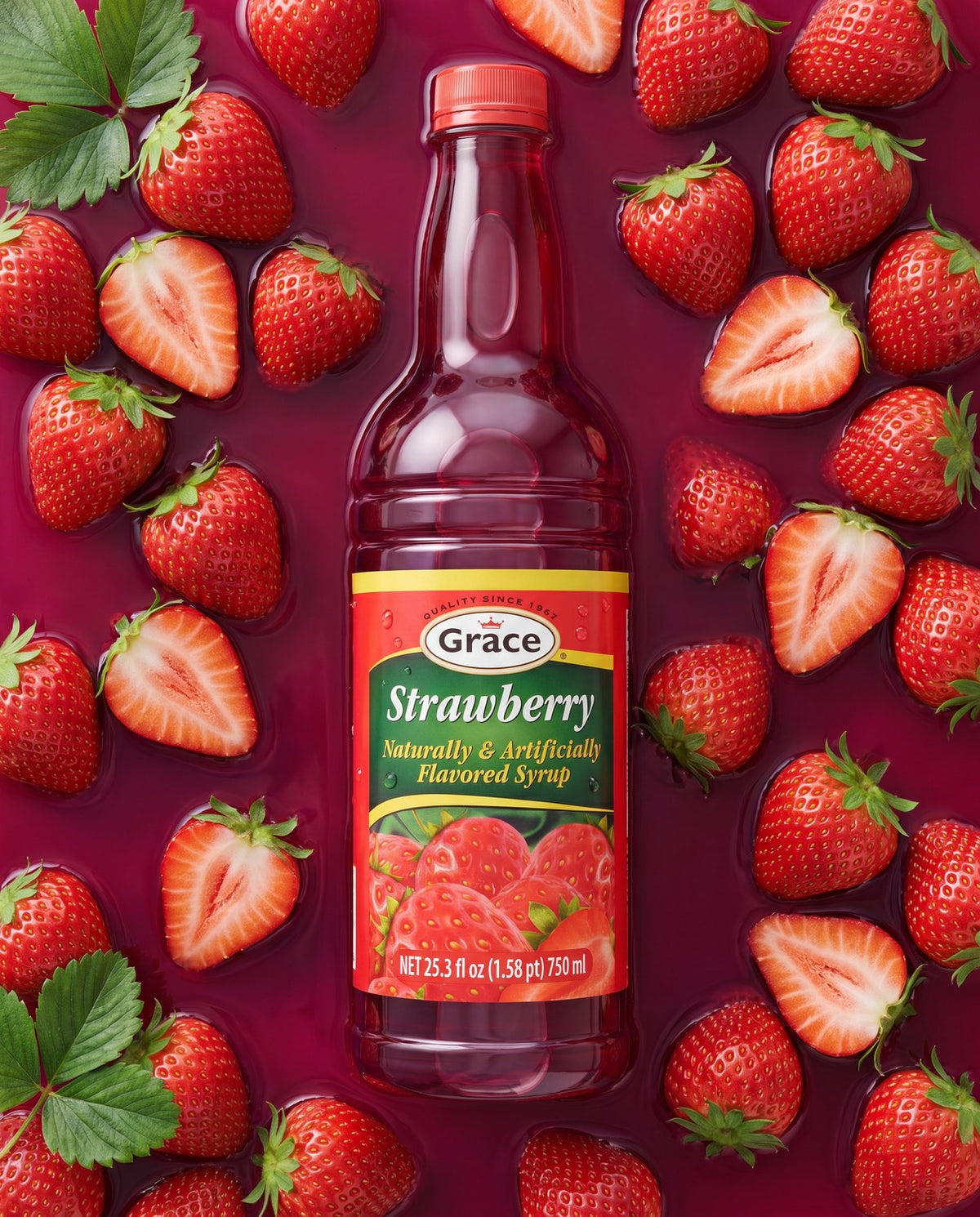 Front view of Grace Strawberry Syrup bottle showcasing its strawberry flavor with whole and sliced strawberries around it
