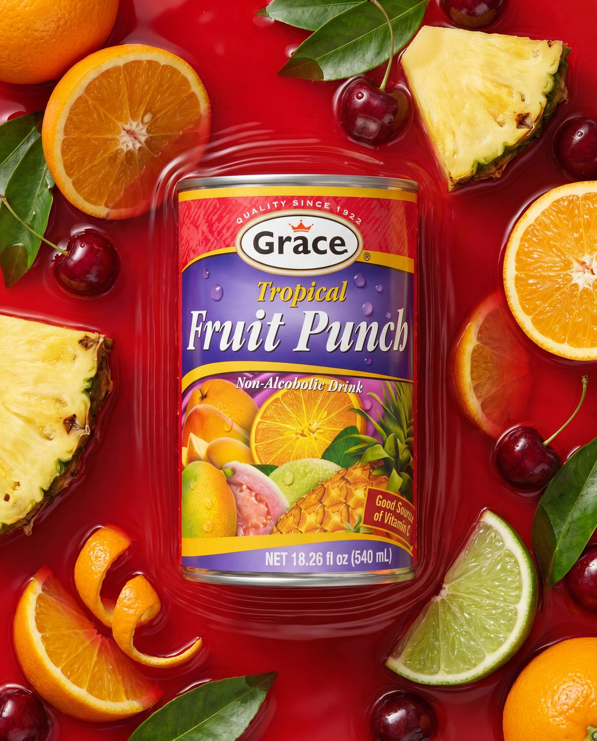 Front view of Grace Tropical Fruit Punch non-alcoholic drink can with fruit label and 18.26 fl oz size on red background