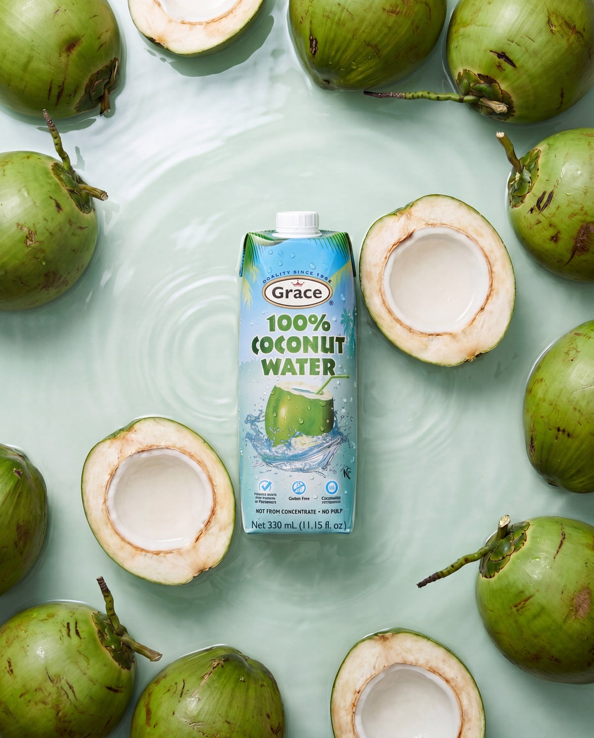 Front view of Grace Prisma Tetra Pack Coconut Water showcasing 100% coconut water with green coconuts floating in water