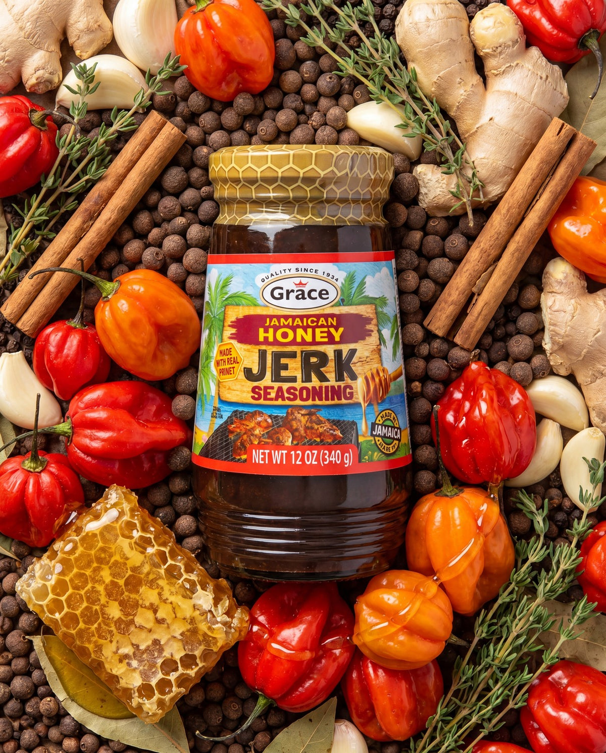 Front view of Grace Honey Jerk Seasoning showcasing 12 oz (340 g) jar with Jamaican honey jerk label, peppers and spices