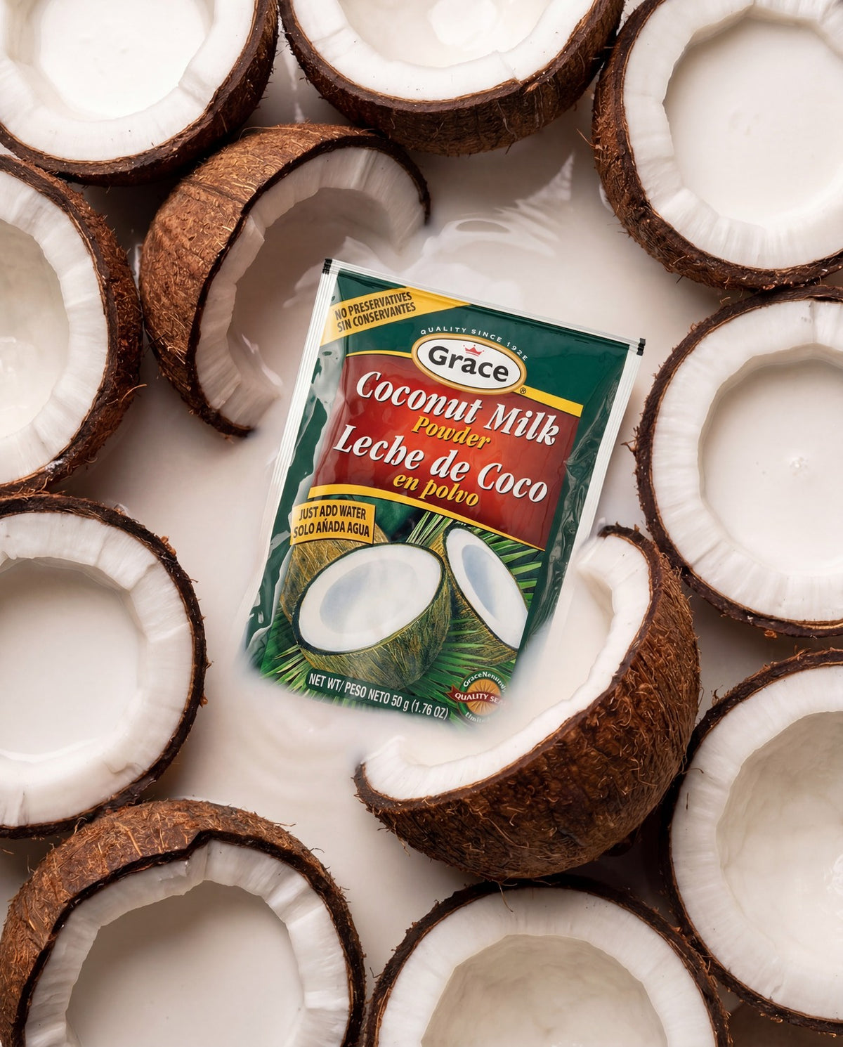 Angled view of Grace Coconut Milk Powder packet showcasing no preservatives and just add water with coconut halves background