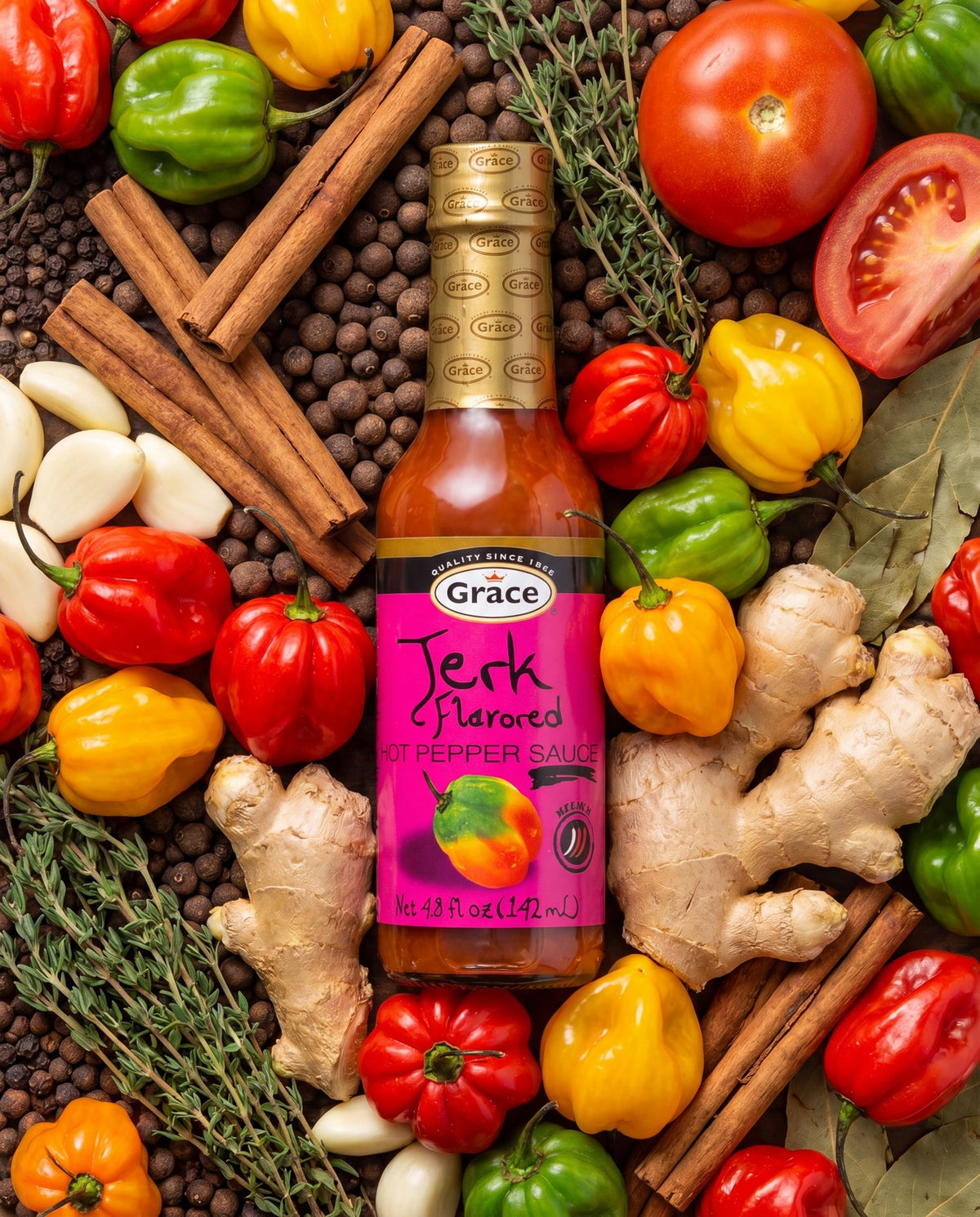 Front view of Grace Jerk Hot Pepper Sauce bottle showcasing its pink label with peppers and Caribbean spices