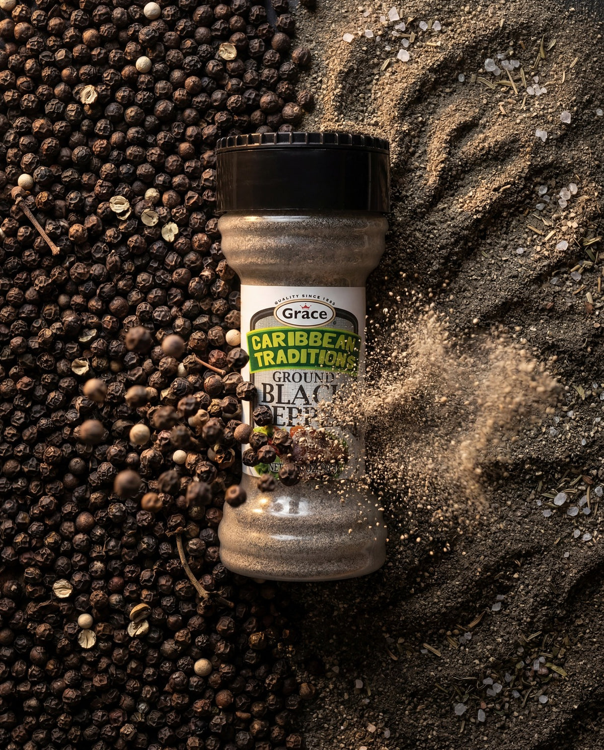 Front view of Grace Caribbean Traditions Ground Black Pepper showcasing the 3 ounce bottle with whole and ground peppercorns