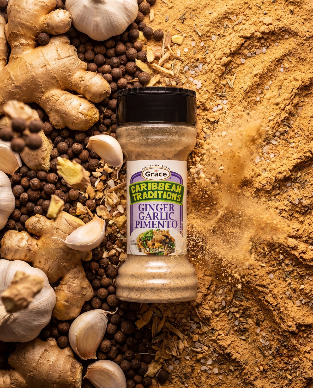 Front view of Grace Caribbean Traditions Ginger Garlic Pimento with ginger, garlic, and pimento surrounding the spice jar