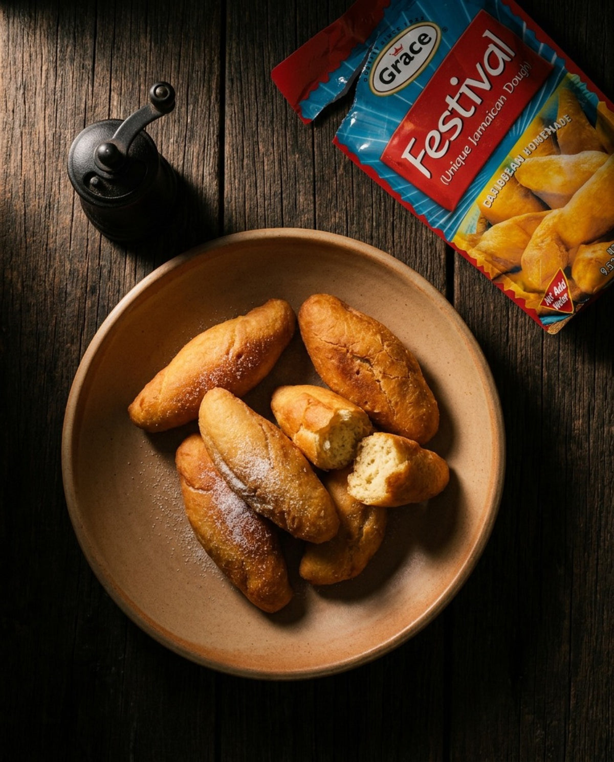 Overhead view of Grace Festival Mix package with golden baked pieces on a plate against a dark wood background