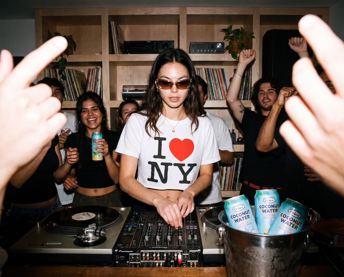 Friends dance around a DJ with Grace coconut water cans at a lively indoor party