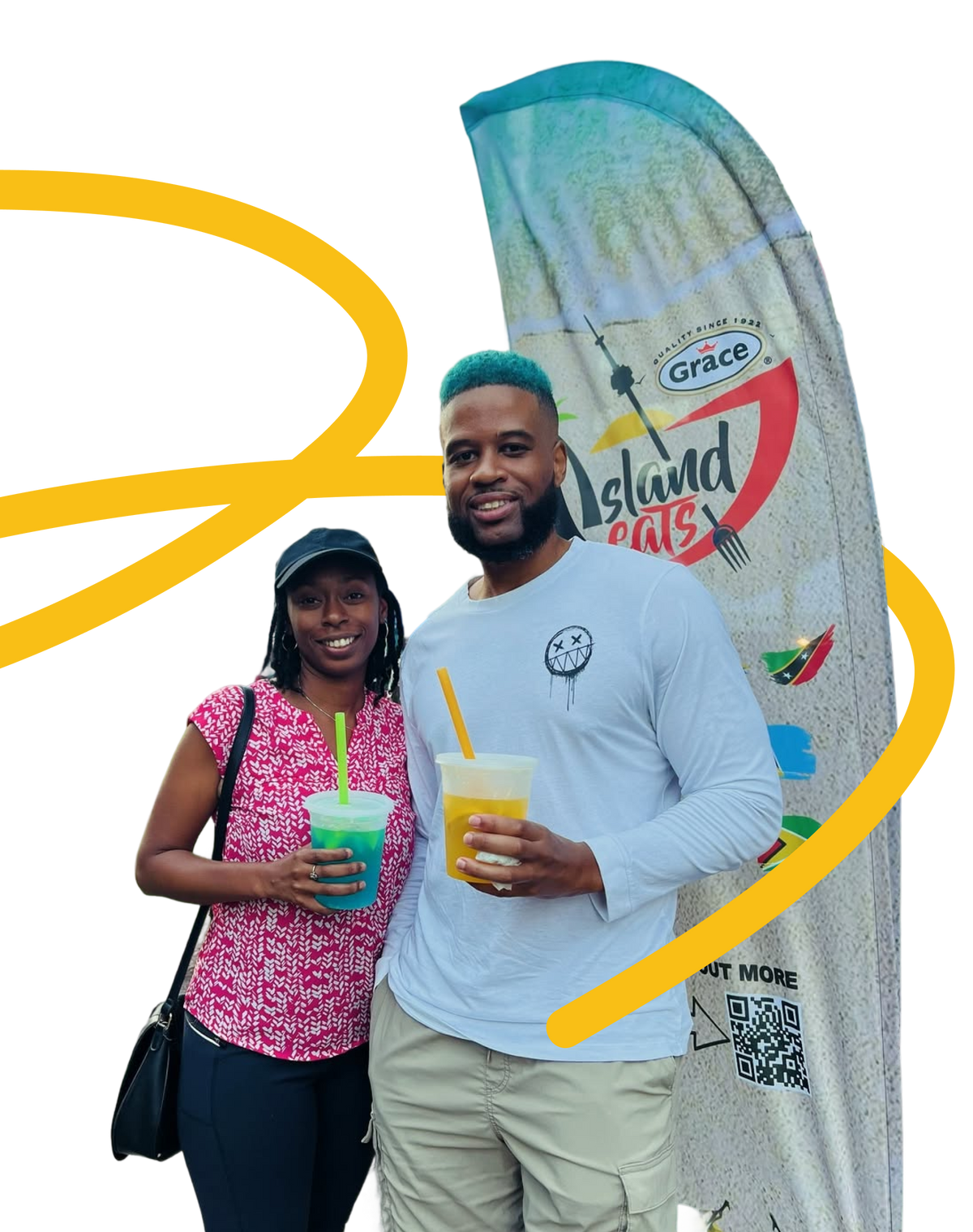 Two people hold colorful drinks beside a Grace Island Eats display