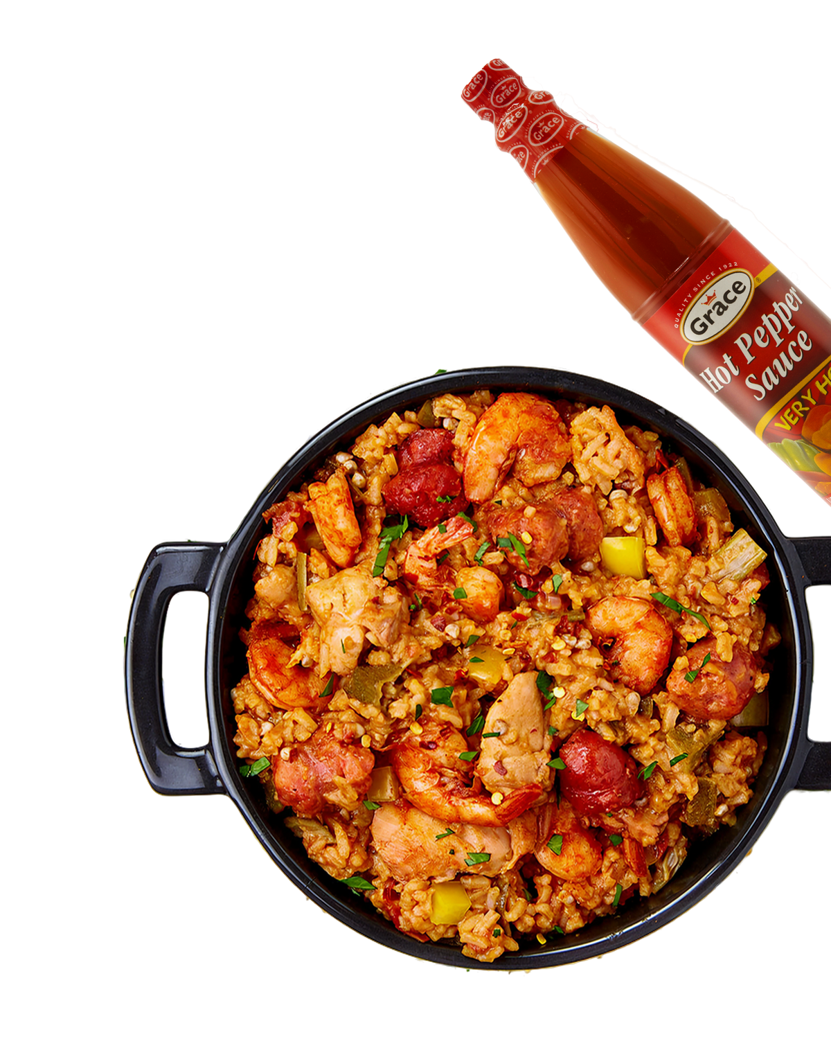 Grace Hot Pepper Sauce bottle beside a bowl of spicy rice with chicken, shrimp, sausage, peppers, and herbs